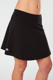 Closer front-side view of a woman wearing an black Kahe Skirt 