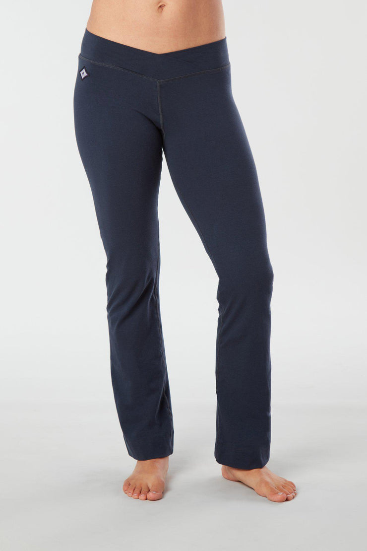 Women lower body showing legs and feet facing forward wearing dark blue colored organic cotton Pono yoga pants
