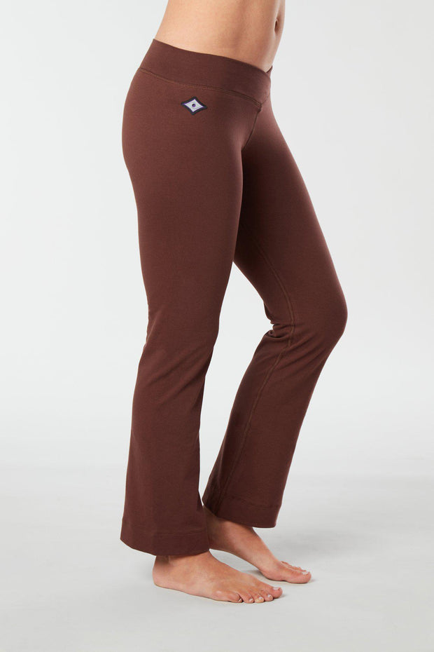 Women lower body showing legs and feet facing sideways wearing brown colored organic cotton Pono yoga pants