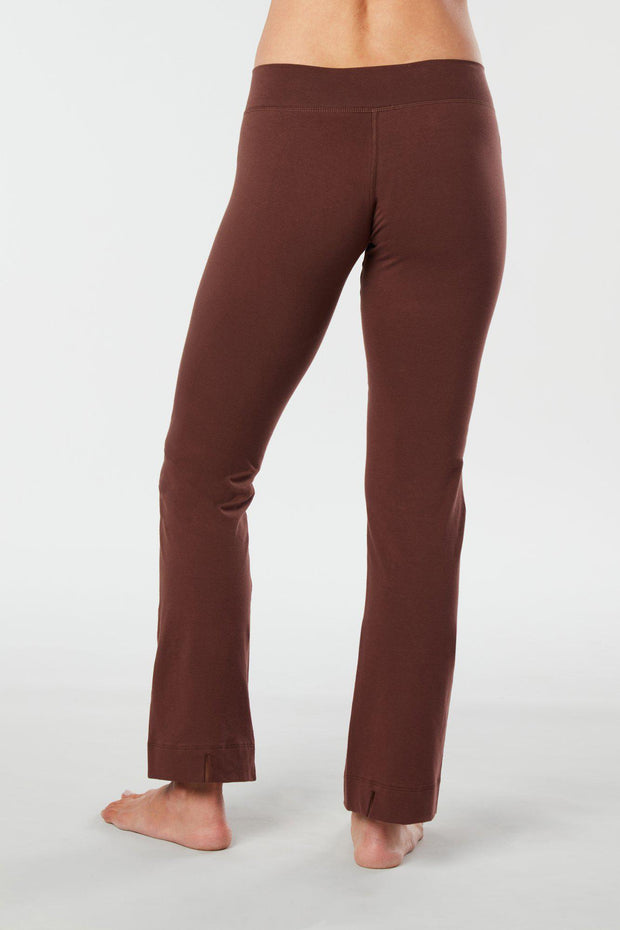 Women lower body showing legs and feet facing backward wearing brown colored organic cotton Pono yoga pants