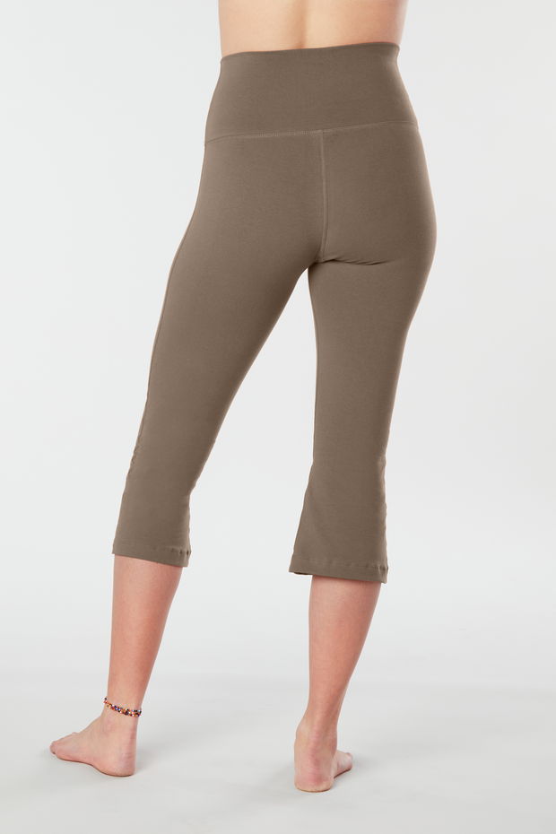 Woman's lower half facing backward of her body showing caribou colored organic cotton Moana Capri yoga pants