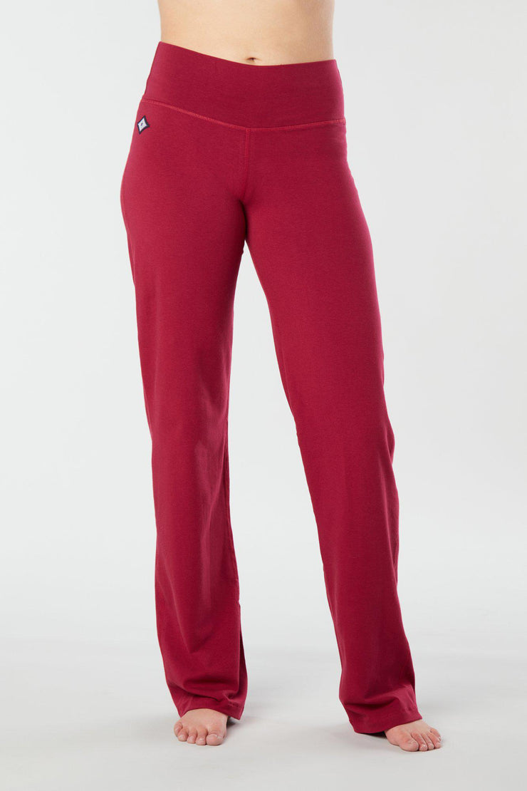 Woman's forward facing legs showing pair of red organic cotton Luana Pants yoga pants