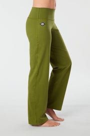 Woman's side facing legs showing pair of lime green organic cotton Luana Pants yoga pants