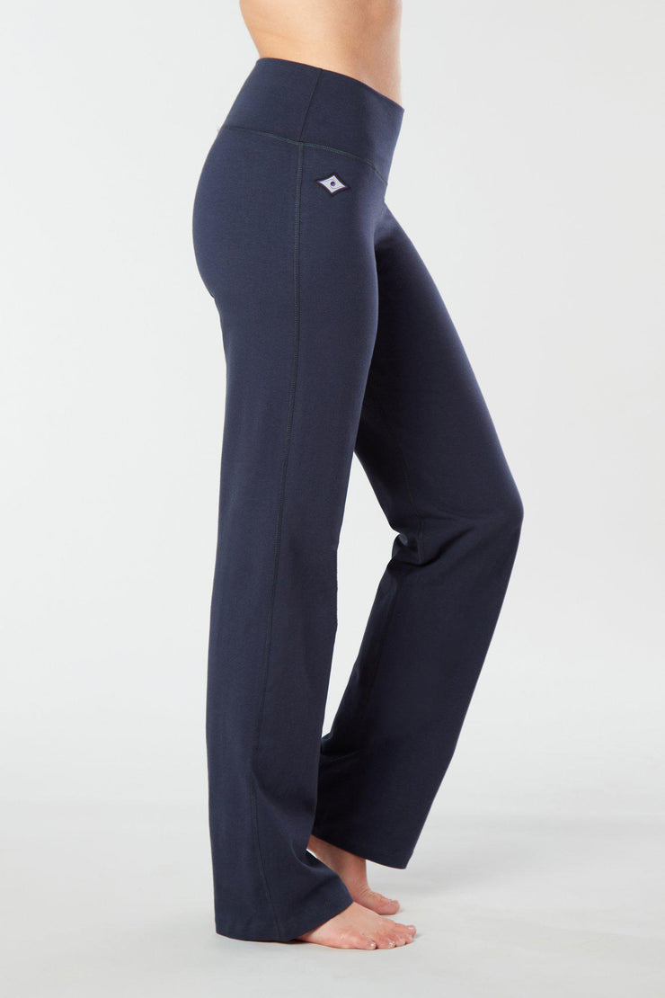 Woman's side facing legs showing pair of Navy Blue organic cotton Luana Pants