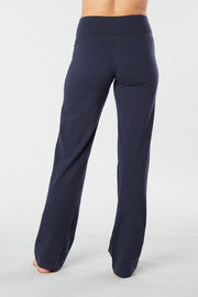Woman's back facing legs showing pair of Navy Blue organic cotton Luana Pants