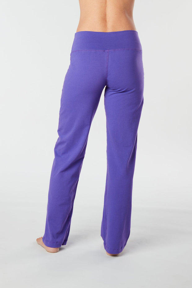 Woman's back facing legs showing pair of purple colored organic cotton Luana Pants yoga pants