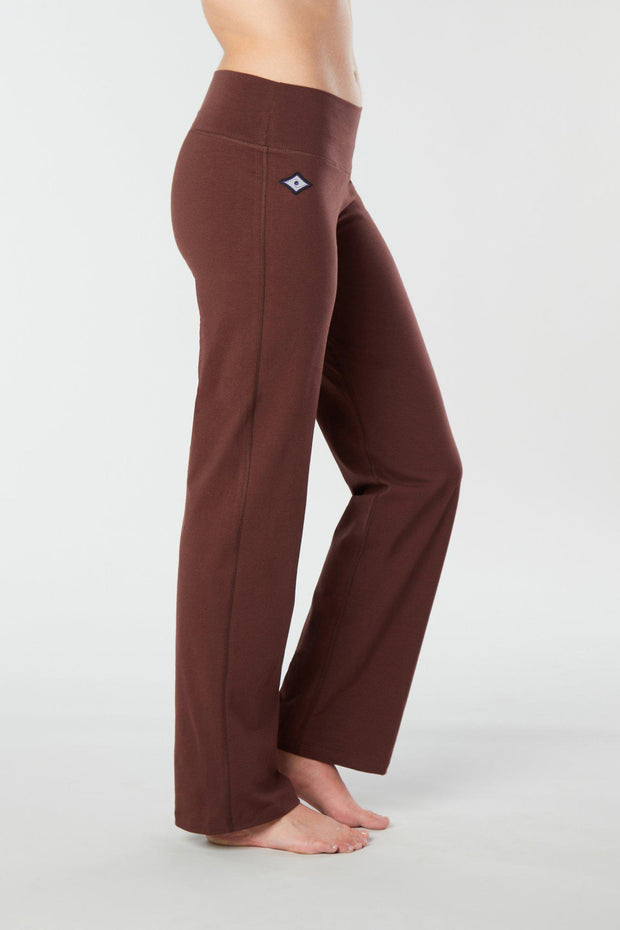 Woman's side facing legs showing pair of brown organic cotton Luana Pants yoga pants