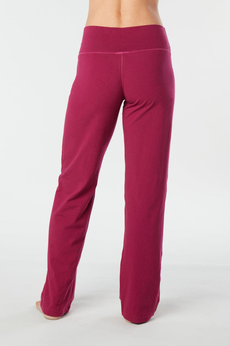 Woman's back facing legs showing pair of rose colored organic cotton Luana Pants yoga pants