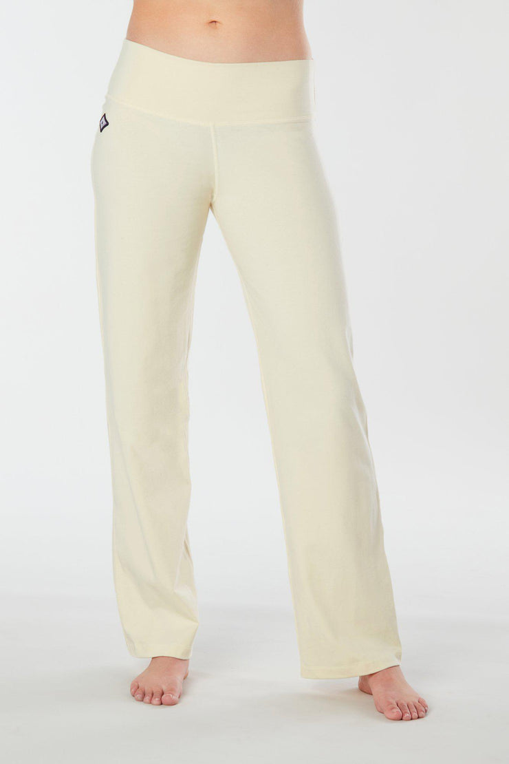 Woman's forward facing legs showing pair of white organic cotton Luana Pants yoga pants