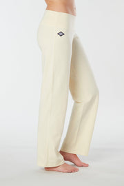 Woman's side facing legs showing pair of white organic cotton Luana Pants yoga pants