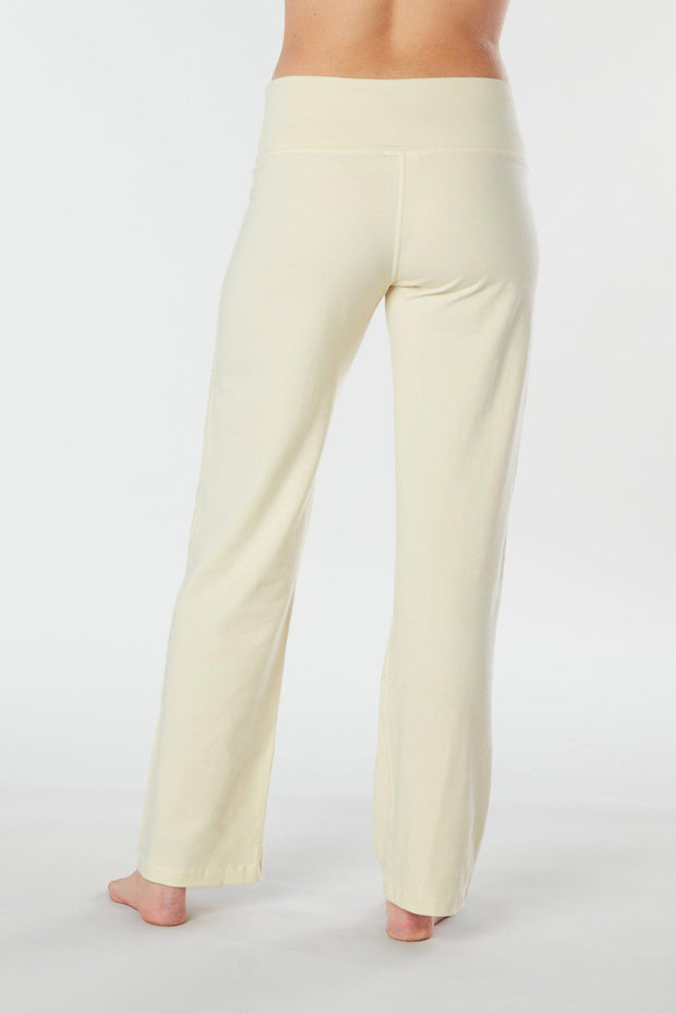 Woman's back facing legs showing pair of white organic cotton Luana Pants yoga pants