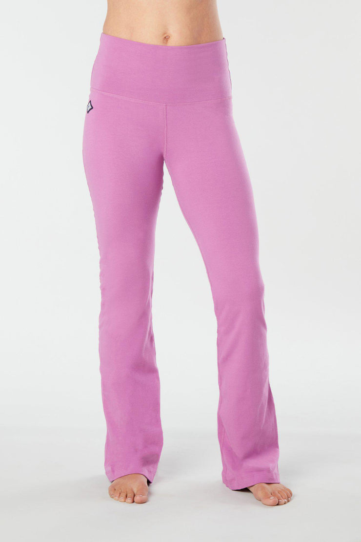 Woman's lower half facing forward wearing pink colored organic cotton Moana Yoga Pants