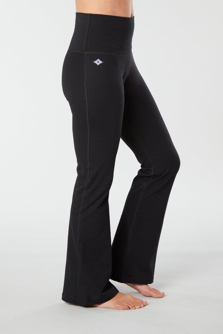 Woman's lower half facing sideways wearing black colored organic cotton Moana Yoga Pants