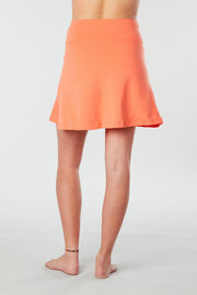 Back view of a woman wearing an orange Kahe Skirt 