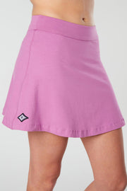 mid body photo of a women wearing a pink kahe skirt