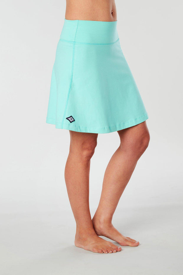 Front-side view of a woman wearing an aqua Kahe Skirt 