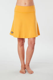 Front view of a woman wearing an yellow Kahe Skirt 