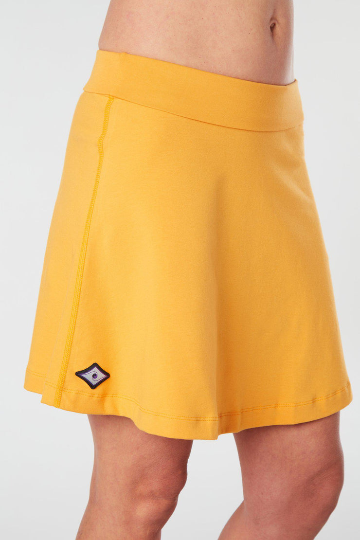 Close front-side view of a woman wearing an yellow Kahe Skirt 