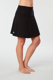 Front-side view of a woman wearing an black Kahe Skirt 