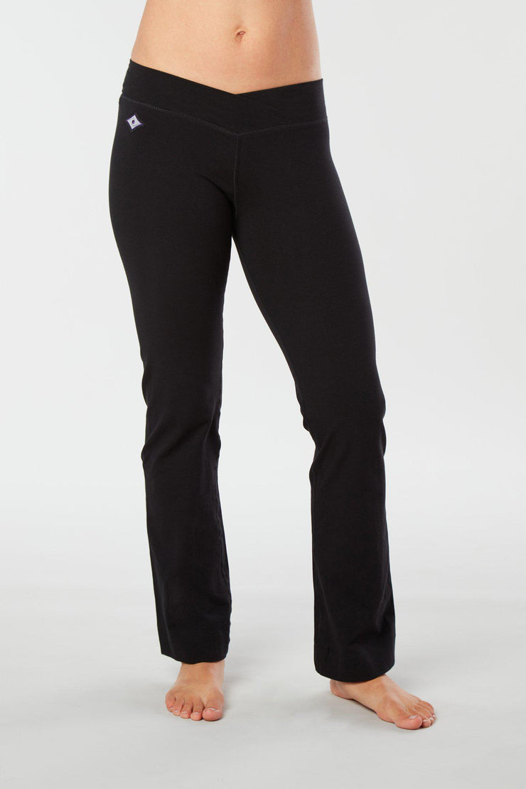 Women lower body showing legs and feet facing forward wearing black colored organic cotton Pono yoga pants