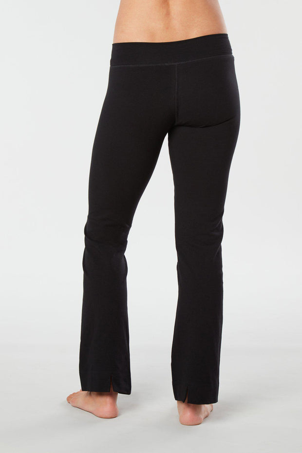 Women lower body showing legs and feet facing backward wearing black colored organic cotton Pono yoga pants