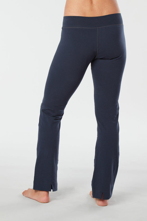 Women lower body showing legs and feet facing backward wearing dark blue colored organic cotton Pono yoga pants