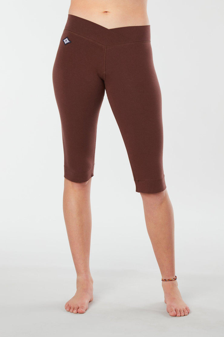Women lower body showing legs and feet facing forwards wearing brown colored organic cotton Pono Capri yoga pants