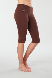 Women lower body showing legs and feet facing sideways wearing  brown colored organic cotton  Pono Capri yoga pants