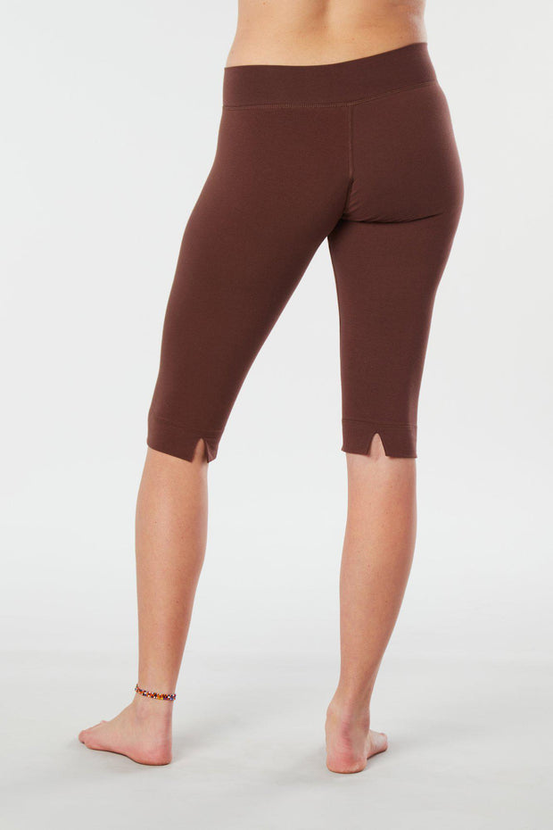 Women lower body showing legs and feet facing backwards wearing brown colored organic cotton Pono Capri yoga pants