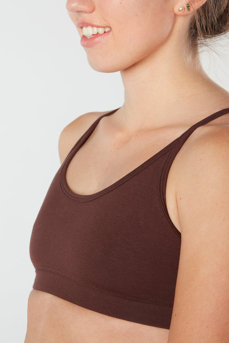 Woman facing forward up close view of brown colored organic cotton Maha yoga top