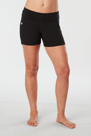 Woman legs front facing wearing matching black colored organic cotton Luana Shorts 