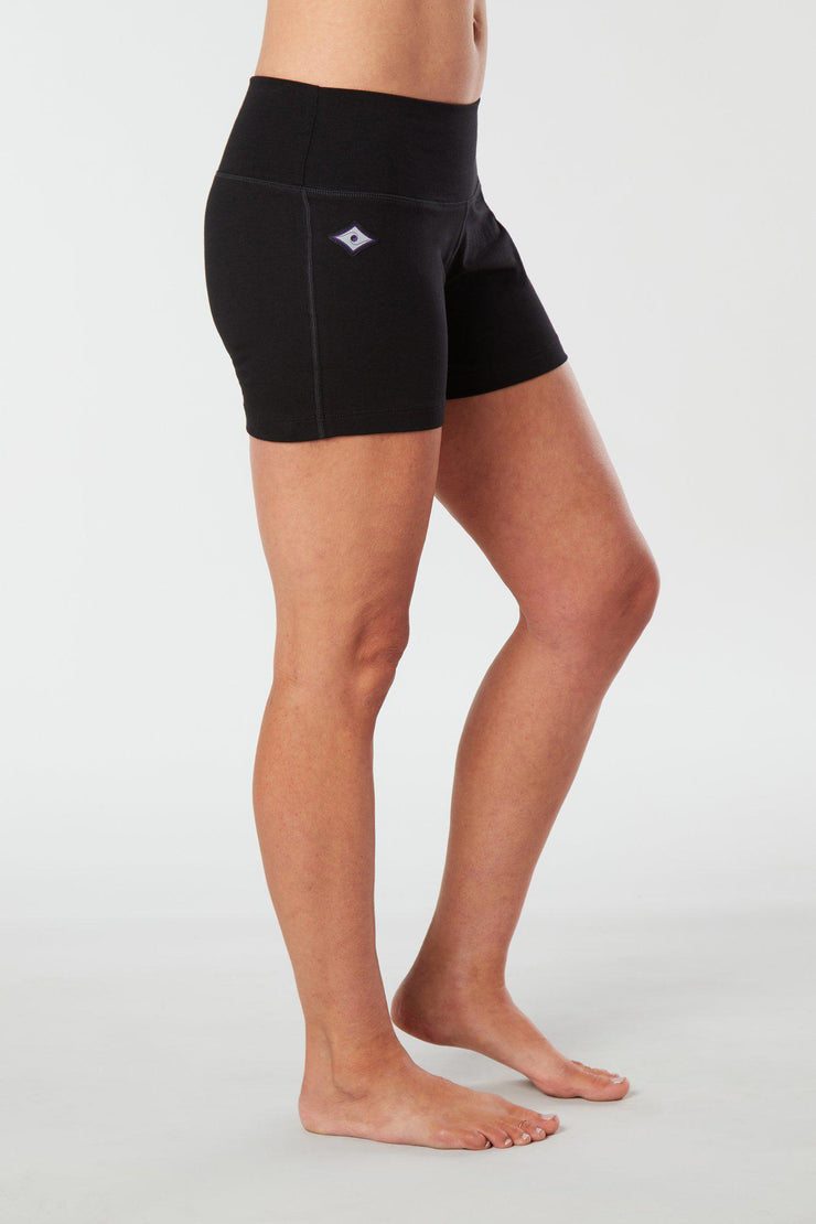 Woman legs side facing wearing matching black colored organic cotton Luana Shorts 