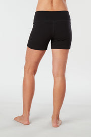Woman legs back facing wearing matching black colored organic cotton Luana Shorts 