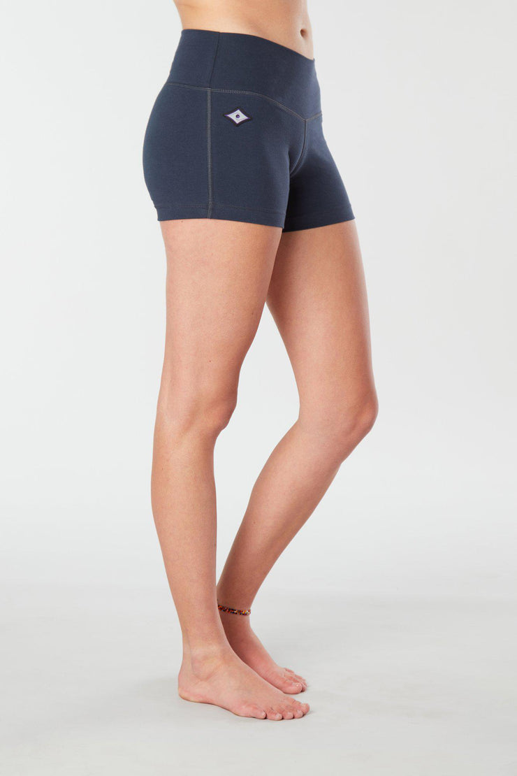 Woman legs side facing wearing matching navy blue colored organic cotton Luana Shorts 