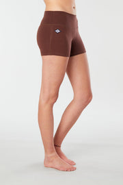 Woman legs side facing wearing matching brown colored organic cotton Luana Shorts 