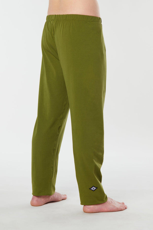 Man standing with side back view of lime green colored organic cotton Mana yoga pants