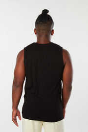 Man facing backward wearing black colored organic cotton Mana yoga tank top