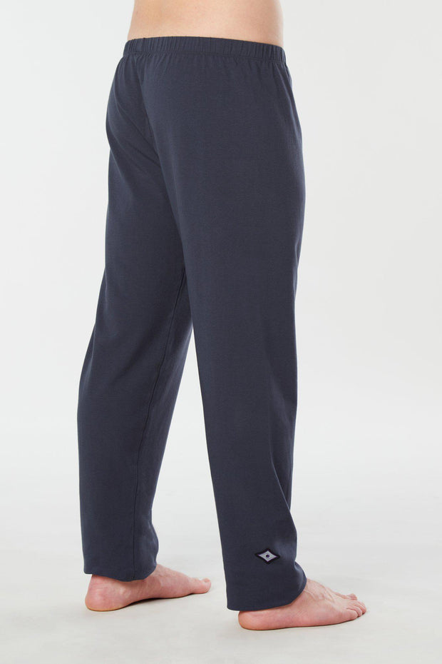 Man's legs facing side back view of navy blue colored organic cotton Mana yoga pants