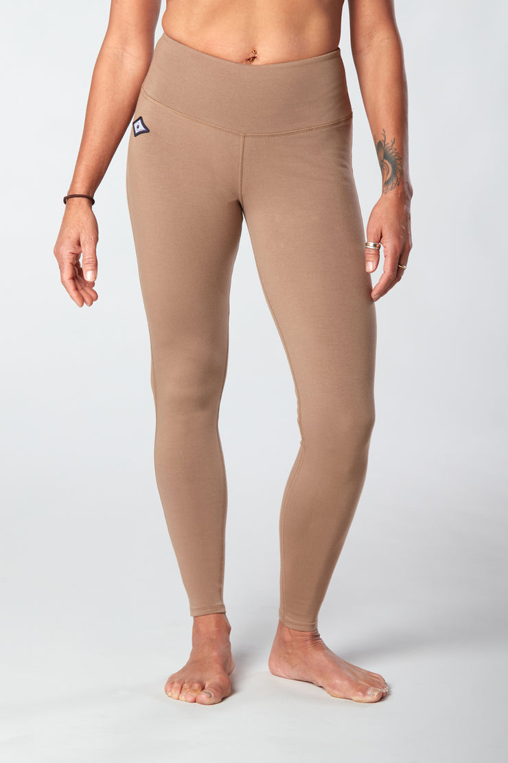 Woman's forward facing legs showing pair of tan organic cotton Luana Legging yoga pants
