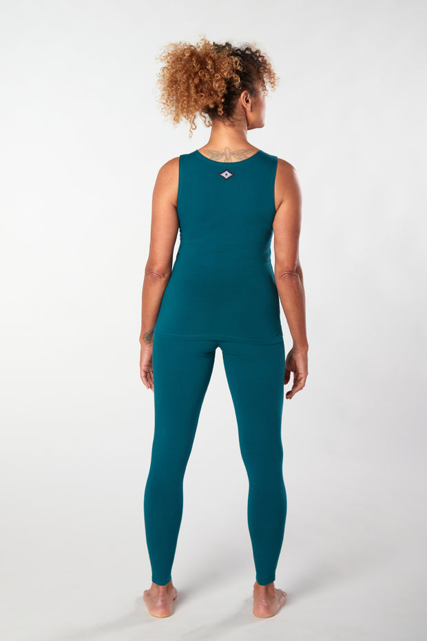 Woman facing backwards showing matching teal organic cotton Luana Legging yoga pants and top