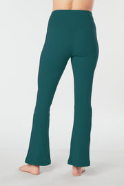 Woman's lower half facing backward wearing teal colored organic cotton Moana Yoga Pants