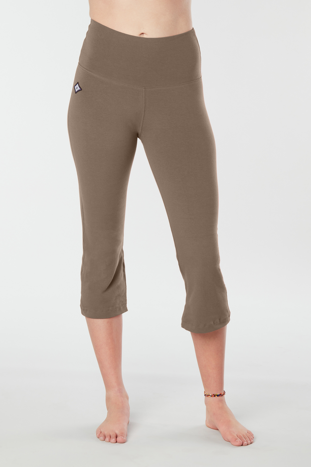 Woman's lower half facing forward of her body showing caribou colored organic cotton Moana Capri yoga pants