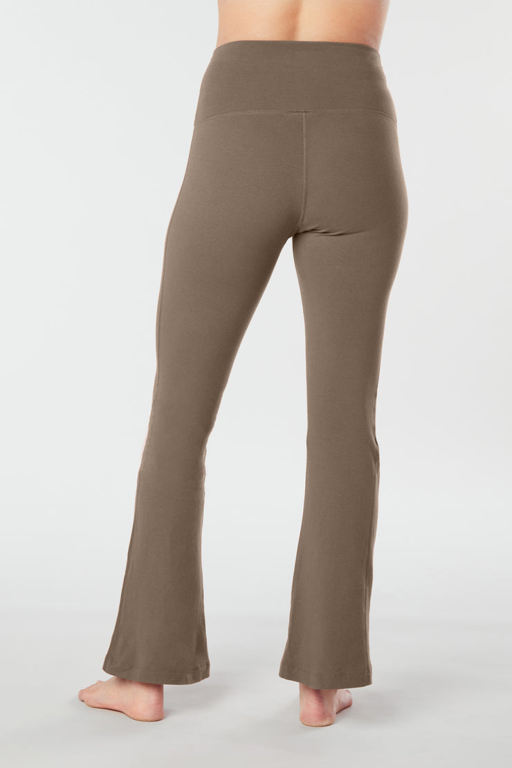 Woman's lower half facing backwards wearing tan colored organic cotton Moana Yoga Pants