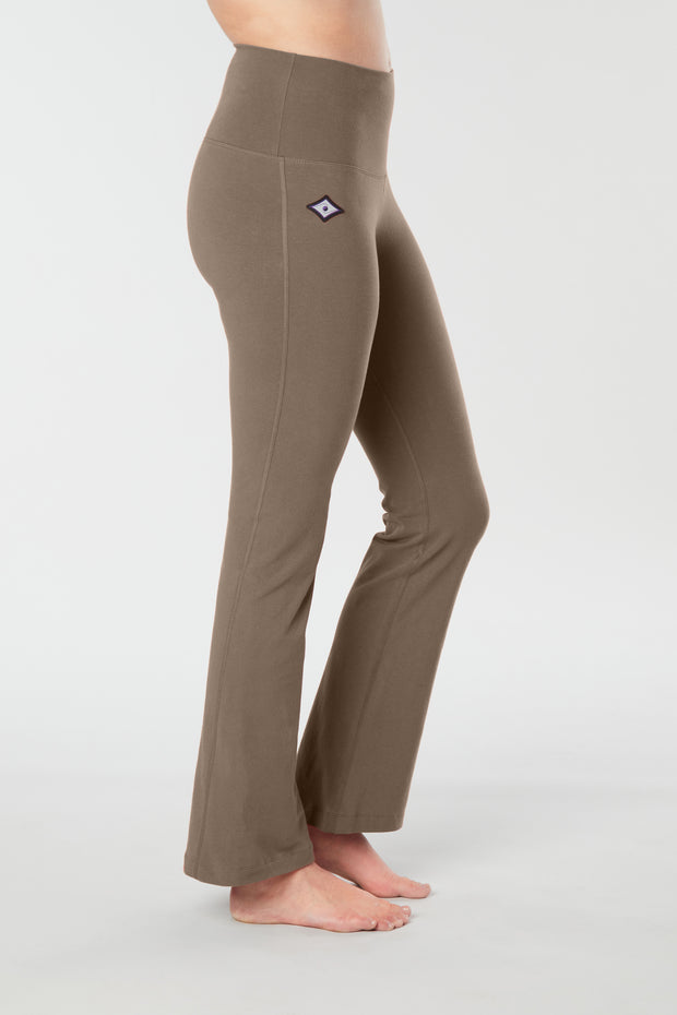 Woman's lower half facing sideways wearing caribou colored organic cotton Moana Yoga Pants