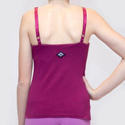 Woman showing her back with hand on hips wearing magenta organic cotton Lilly Top