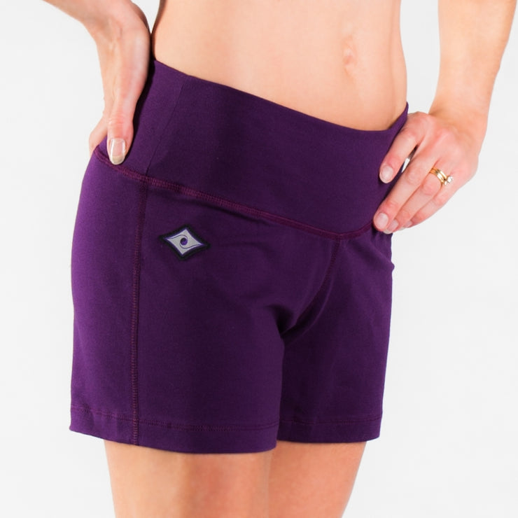 Woman legs side facing wearing matching purple colored organic cotton Luana Shorts 