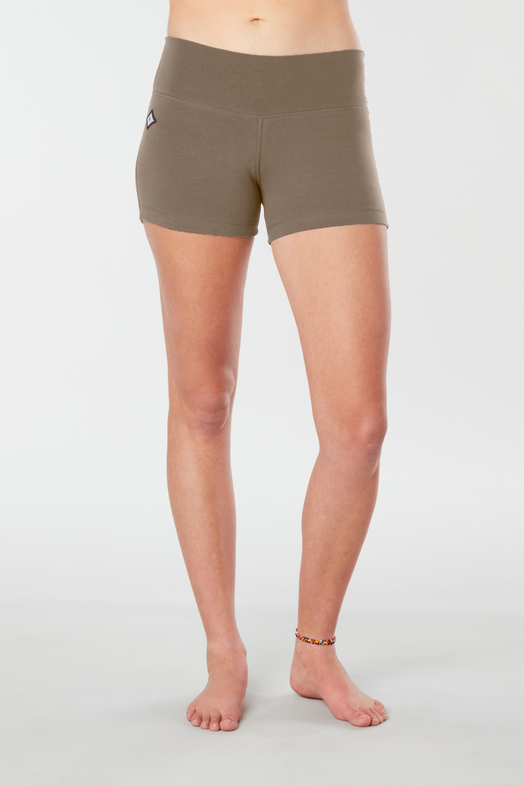 Woman legs forward facing wearing matching tan colored organic cotton Luana Shorts 