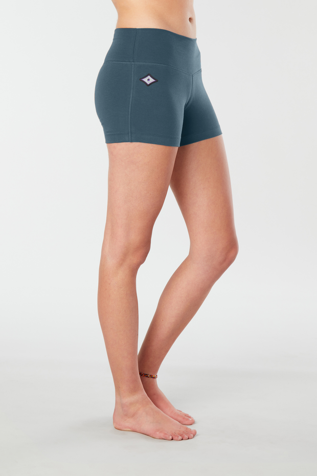  Woman legs side facing wearing matching teal organic cotton Luana Shorts 