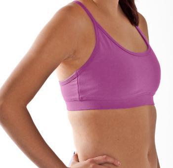 Woman facing side showing close view of pink colored organic cotton Maha yoga top
