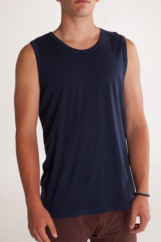 Man facing forward wearing dark blue colored organic cotton Mana yoga tank top